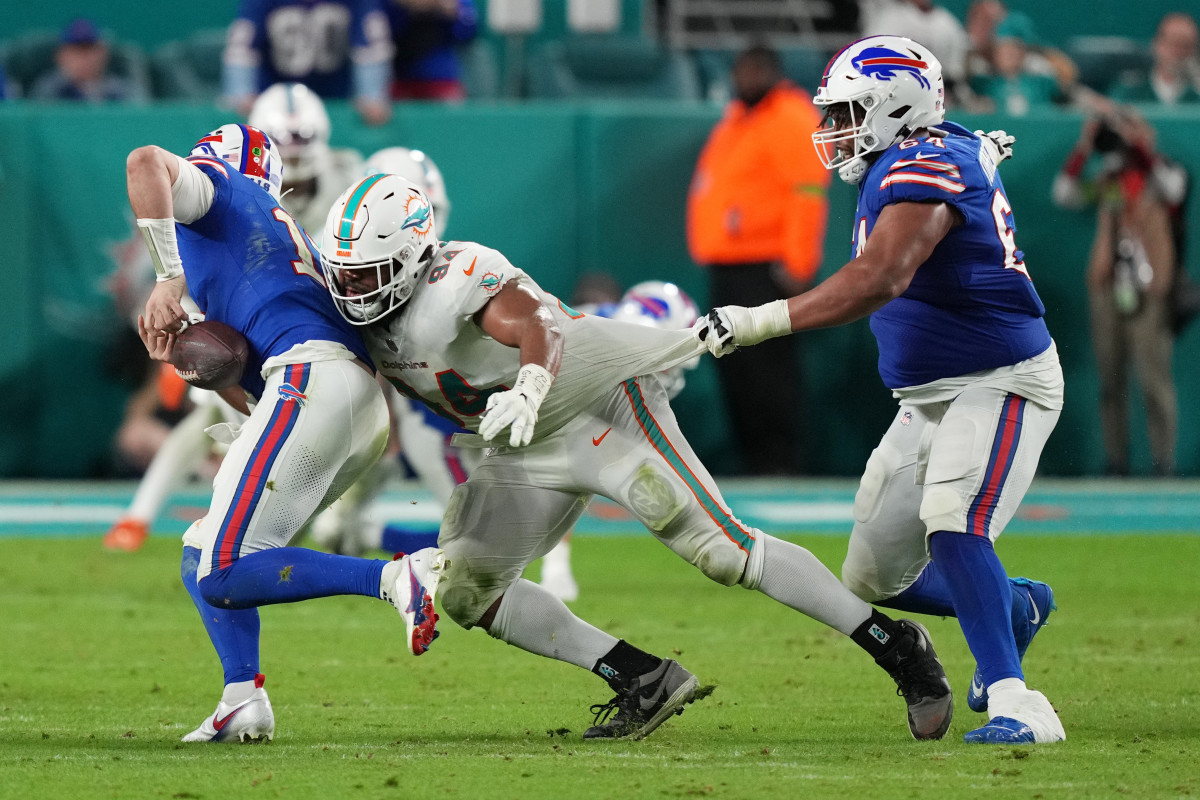 Jan 7, 2024; Miami Gardens, Florida, USA; Miami Dolphins defensive tackle Christian Wilkins (94) strips the ball from Buffalo Bills quarterback Josh Allen (17) as guard O'Cyrus Torrence (64) defends on the play during the second half at Hard Rock Stadium. Mandatory Credit: Jim Rassol-USA TODAY Sports  