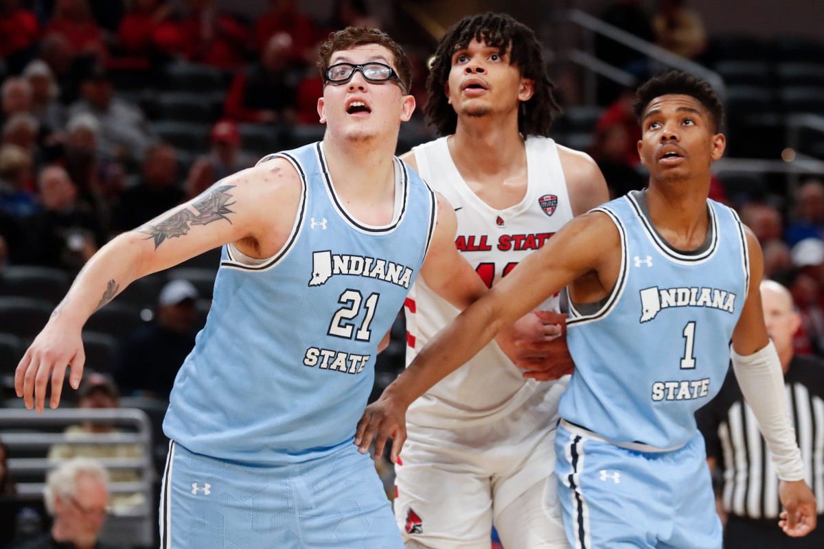 Indiana State Sycamores center Robbie Avila (21) and guard Julian Larry (1) box out Ball State Cardinals forward Basheer Jihad (11) during a men’s basketball game on Dec. 16, 2023, at Gainbridge Fieldhouse in Indianapolis. Indiana State Sycamores won 83-72.