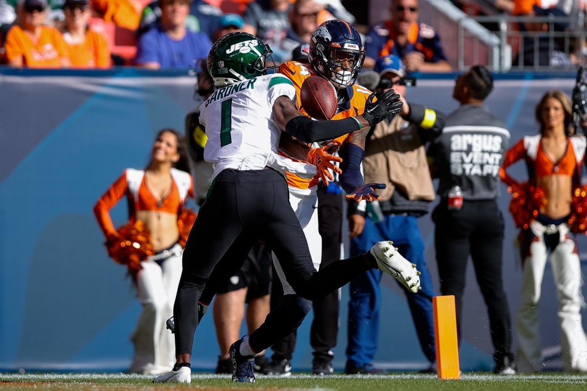 Oct 23, 2022; Denver, Colorado, USA; New York Jets cornerback Sauce Gardner (1) breaks up a pass intended for Denver Broncos wide receiver Courtland Sutton (14) in the second quarter at Empower Field at Mile High.