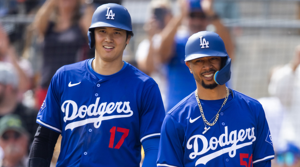 Dodgers designated hitter Shohei Ohtani, left, and second baseman Mookie Betts on the field during spring training