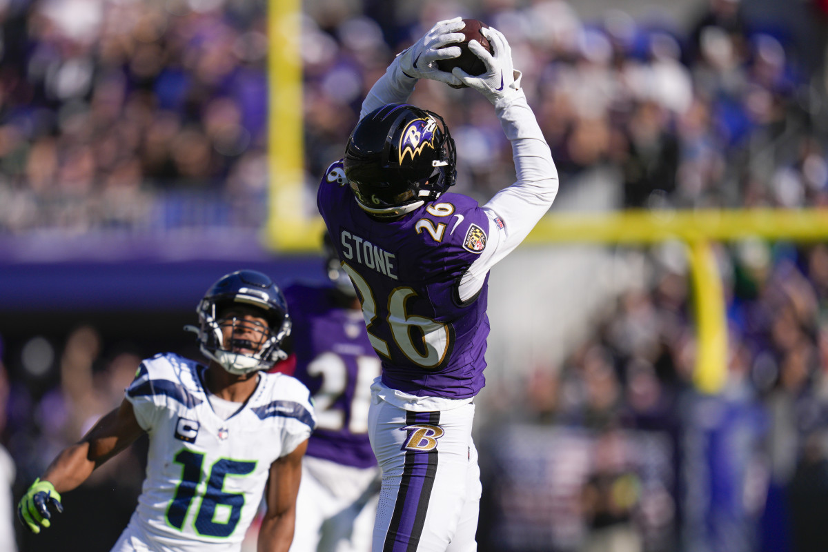 Baltimore Ravens safety Geno Stone (26) catches an interception against the Seattle Seahawks during the first half at M&T Bank Stadium.