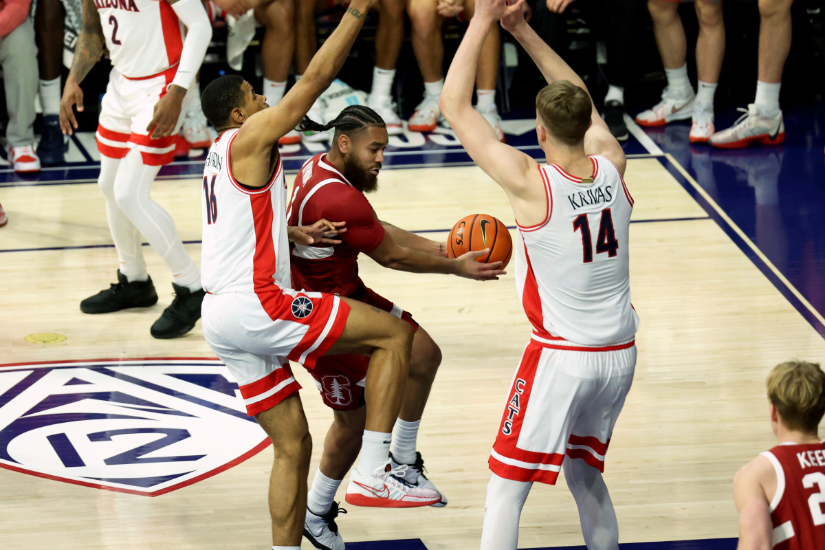 Feb 4, 2024; Tucson, Arizona, USA; Stanford Cardinal guard Jared Bynum (1) drives to the basket against Arizona Wildcats forward Keshad Johnson (16) and center Motiejus Krivas (14) during the first half at McKale Center. Mandatory Credit: Zachary BonDurant-USA TODAY Sports