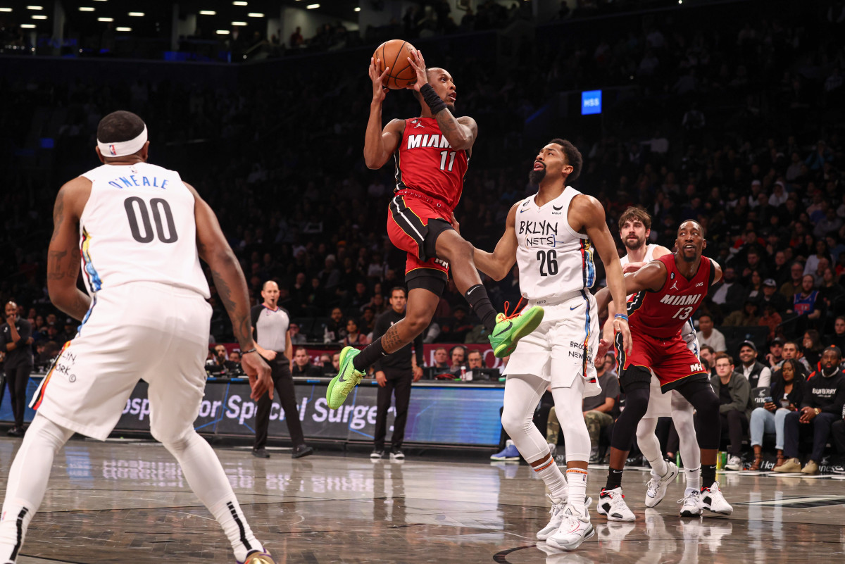 Miami Heat guard Jamaree Bouyea (11) goes to the basket against Brooklyn Nets guard Spencer Dinwiddie (26) and forward Royce O'Neale (00) during the first half at Barclays Center.