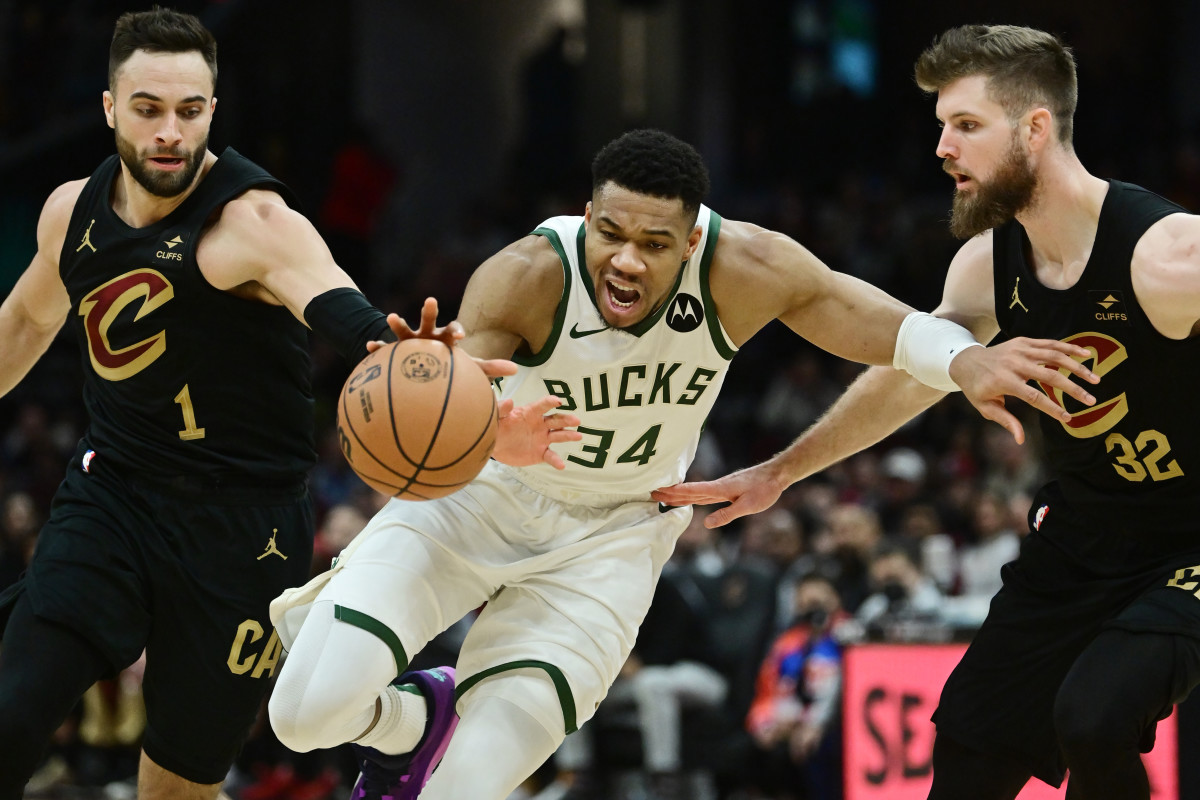 Dec 29, 2023; Cleveland, Ohio, USA; Cleveland Cavaliers guard Max Strus (1) and forward Dean Wade (32) and Milwaukee Bucks forward Giannis Antetokounmpo (34) go for a loose ball during the second half at Rocket Mortgage FieldHouse.