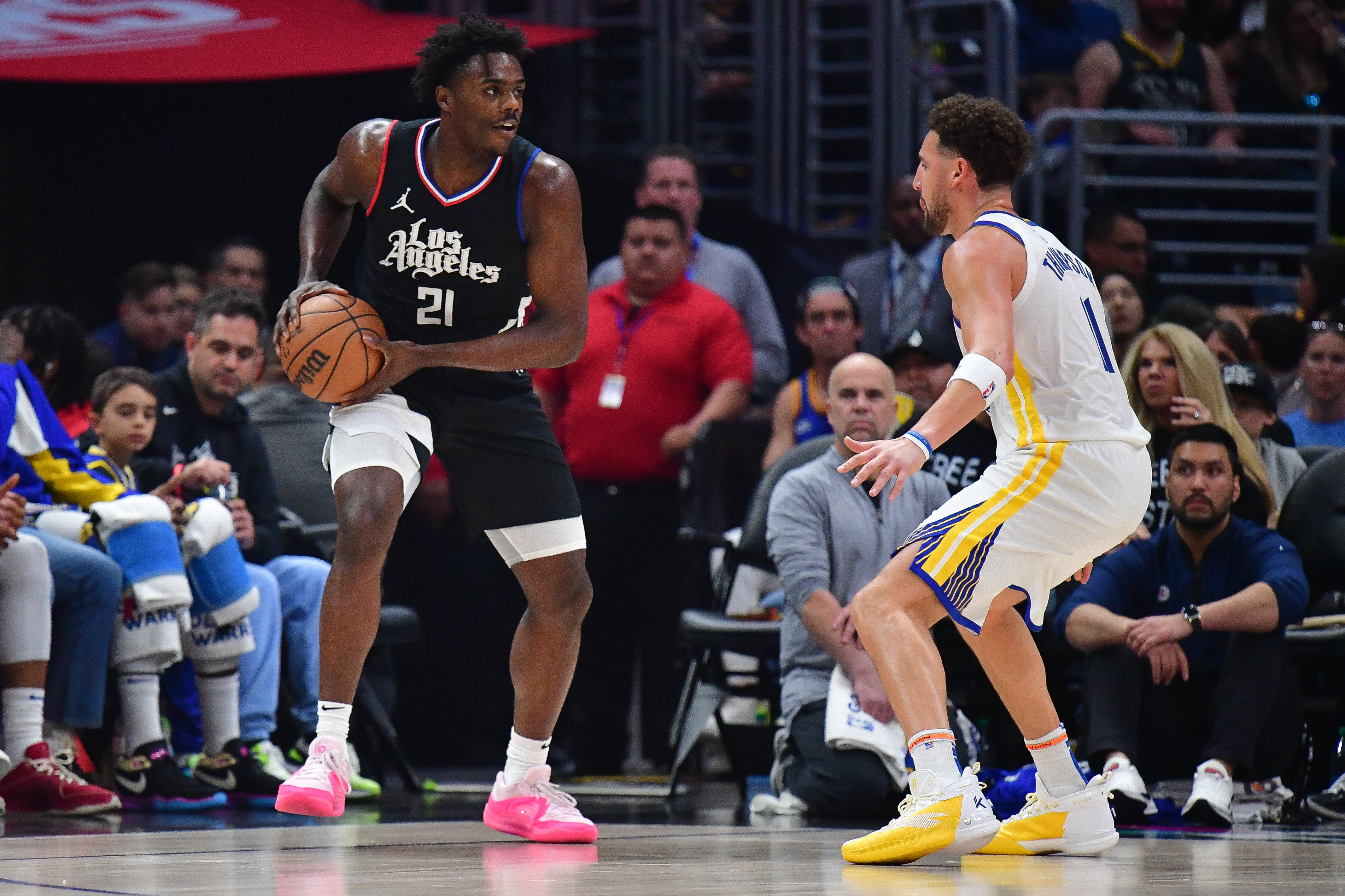 Dec 2, 2023; Los Angeles, California, USA; Los Angeles Clippers guard Kobe Brown (21) controls the ball against Golden State Warriors guard Klay Thompson (11) during the first half at Crypto.com Arena.