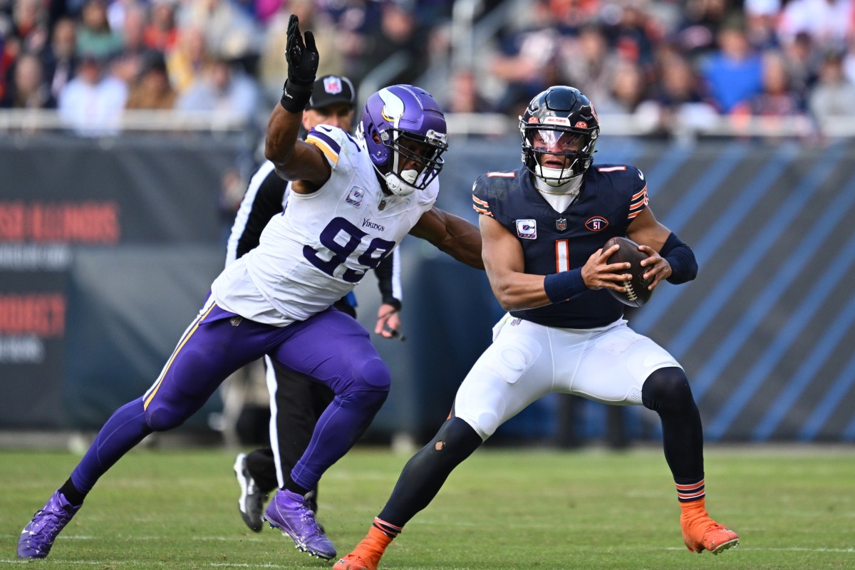 Oct 15, 2023; Chicago, Illinois, USA; Chicago Bears quarterback Justin Fields (1) is pursued by Minnesota Vikings linebacker Danielle Hunter (99) in the second half at Soldier Field.