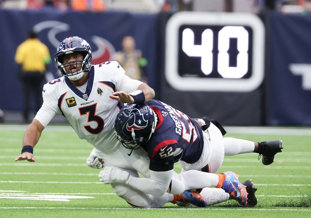 Denver Broncos quarterback Russell Wilson (3) is hit by Houston Texans defensive end Jonathan Greenard (52). Mandatory Credit: Thomas Shea-USA TODAY Sports
