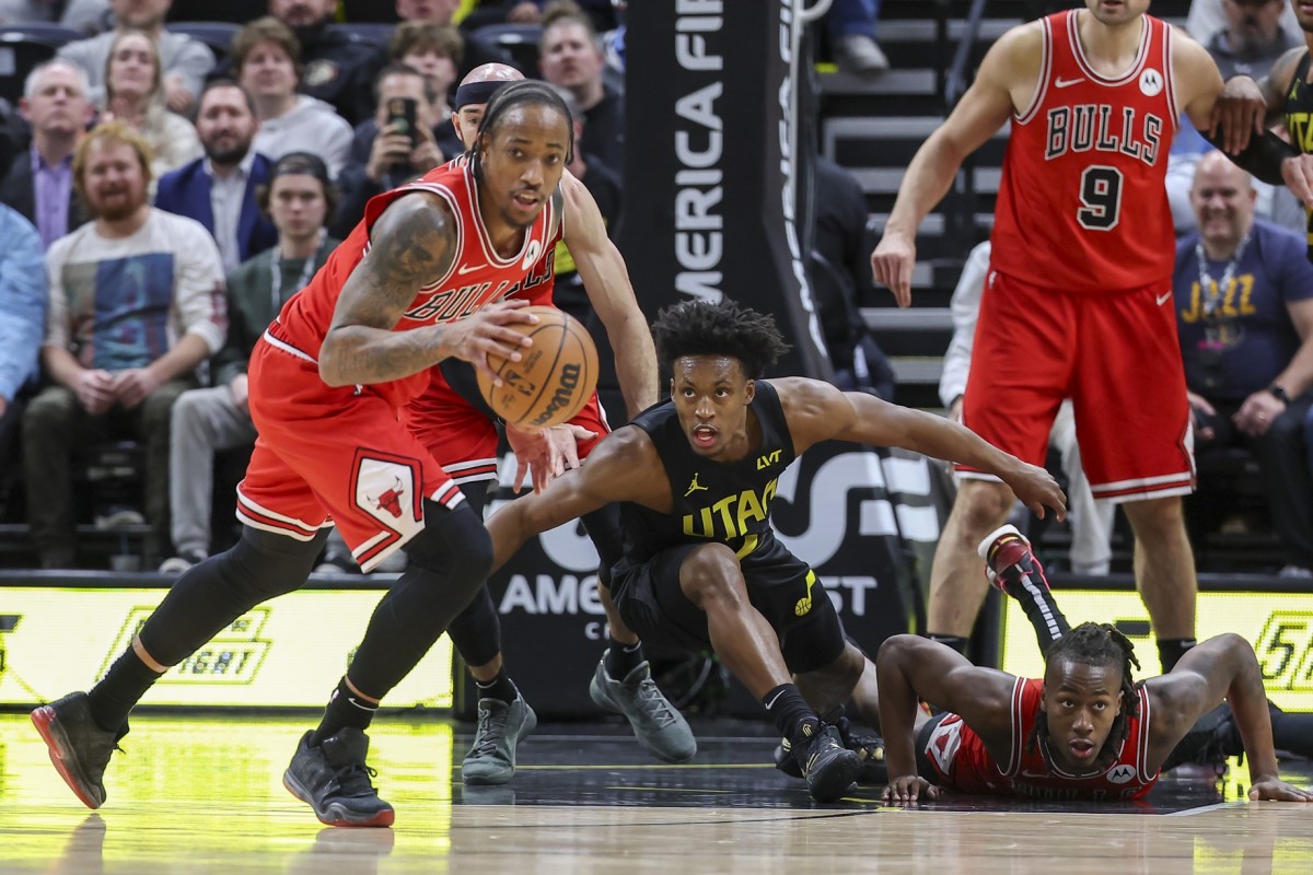 Chicago Bulls forward DeMar DeRozan (left) picks up a loos ball against the Utah Jazz during the fourth quarter at Delta Center.