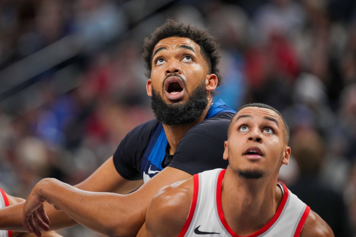 Mar 4, 2024; Minneapolis, Minnesota, USA; Minnesota Timberwolves center Karl-Anthony Towns (32) rebounds against the Portland Trail Blazers forward Kris Murray (8) in the third quarter at Target Center.