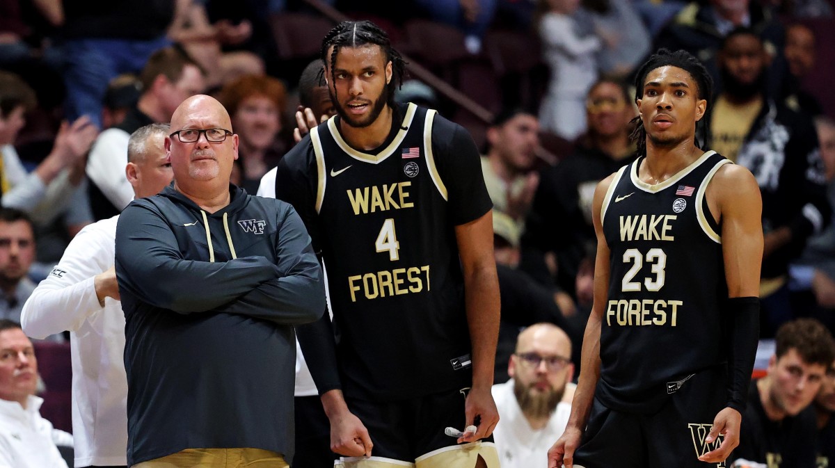 Wake Forest Demon Deacons head coach Steve Forbes talks with Wake Forest Demon Deacons forward Efton Reid III (4) and guard Hunter Sallis (23) during the second half of the game against the Virginia Tech Hokies at Cassell Coliseum.