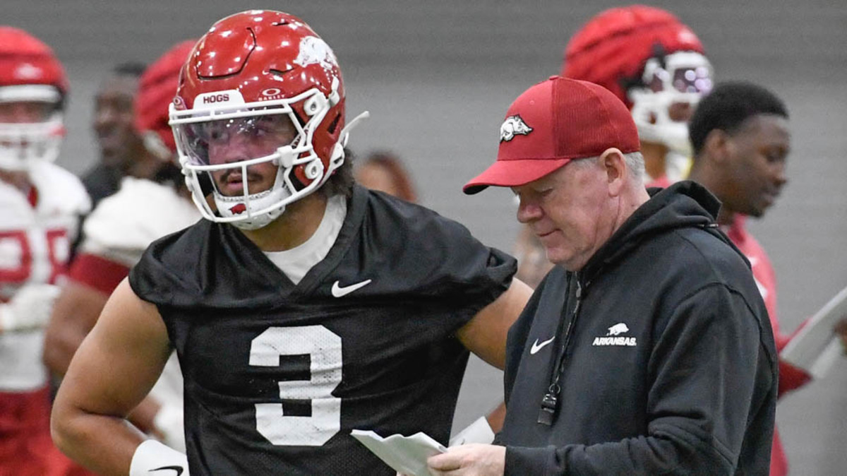 Arkansas Razorbacks quarterback Malachi Singleton with offensive coordinator Bobby Petrino in Friday morning's practice at the indoor field at the football center in Fayetteville, Ark.