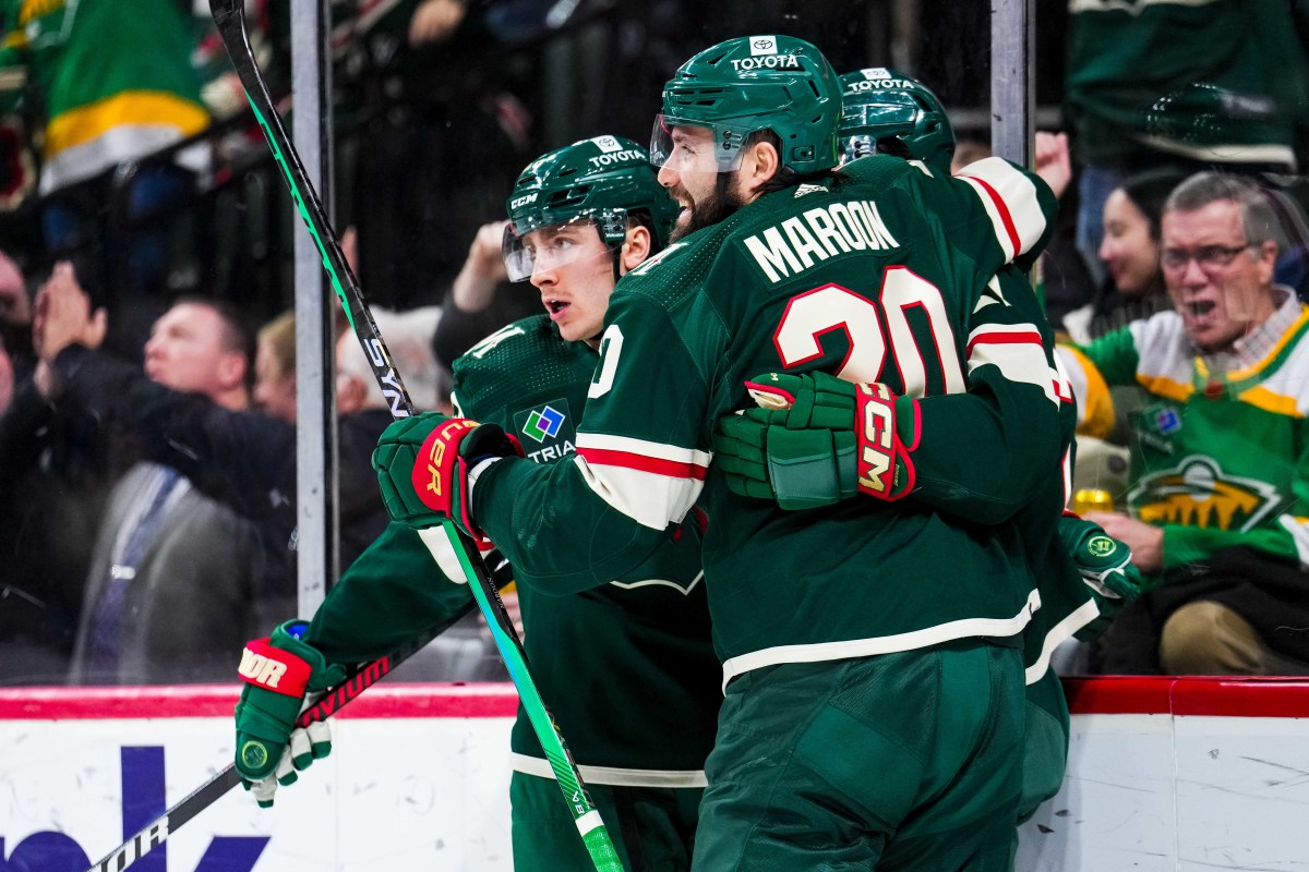 Jan 15, 2024; Saint Paul, Minnesota, USA; Minnesota Wild center Connor Dewar (26) celebrates his goal with left wing Pat Maroon (20) during the second period against the New York Islanders at Xcel Energy Center.