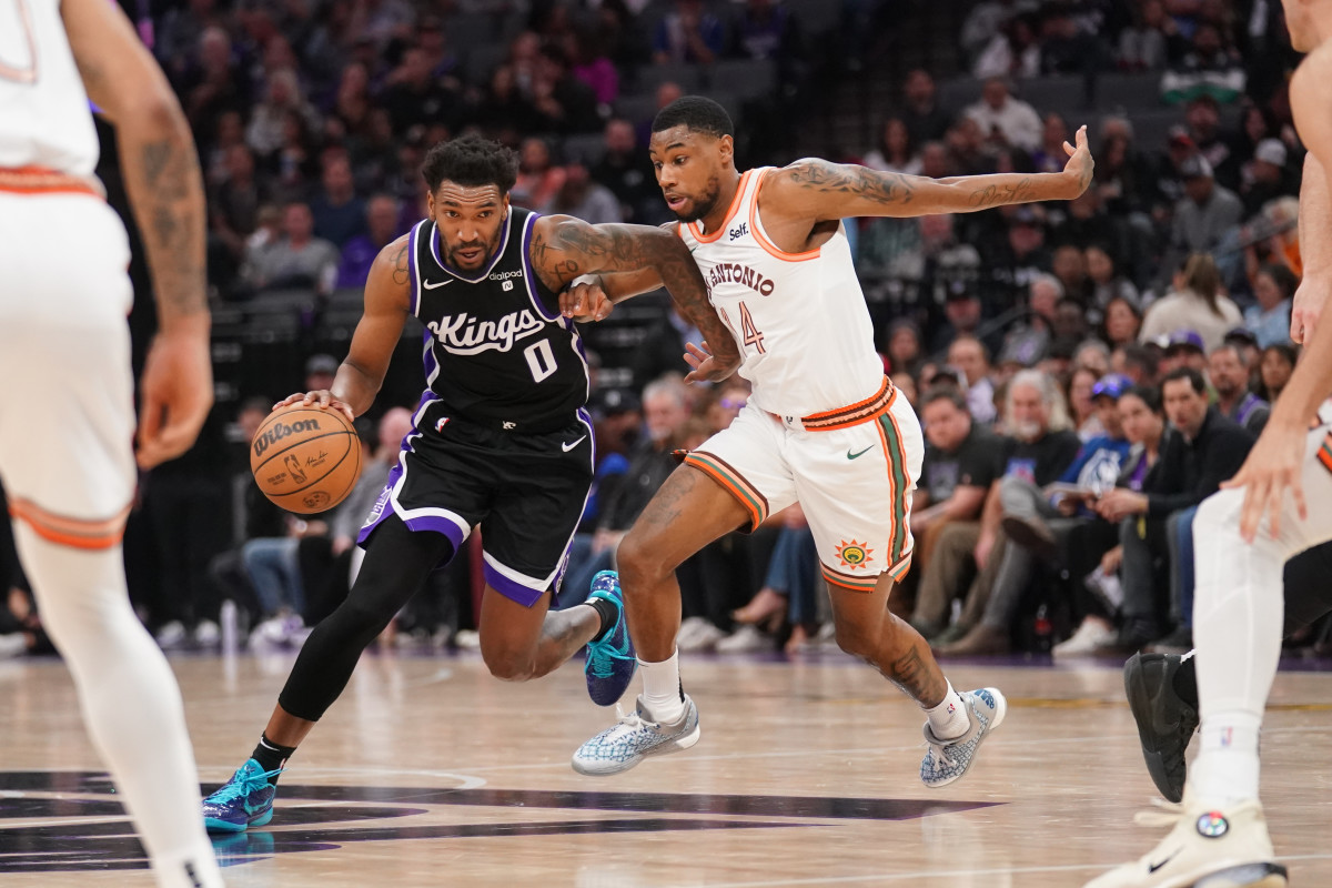 Sacramento Kings guard Malik Monk (0) dribbles past San Antonio Spurs guard Blake Wesley (14) in the second quarter at the Golden 1 Center.