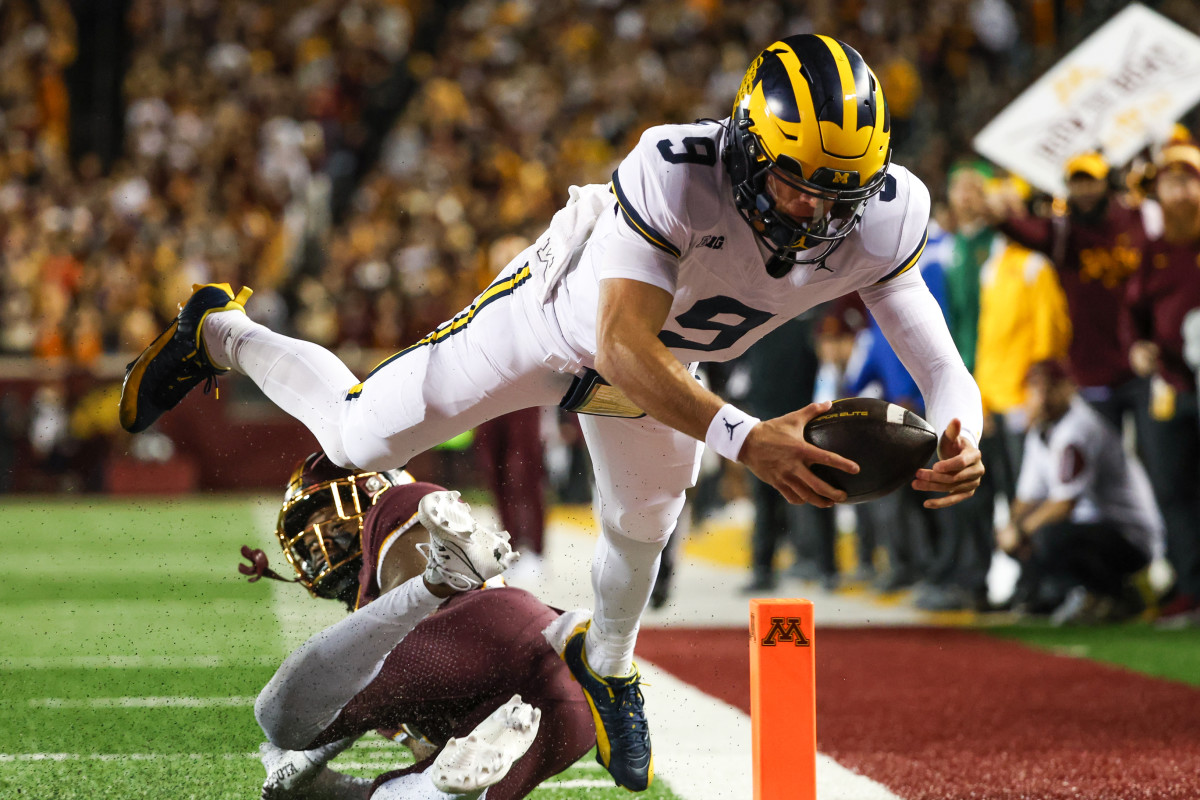 Oct 7, 2023; Minneapolis, Minnesota, USA; Michigan Wolverines quarterback J.J. McCarthy (9) dives for a touchdown against the Minnesota Golden Gophers during the second quarter at Huntington Bank Stadium. 