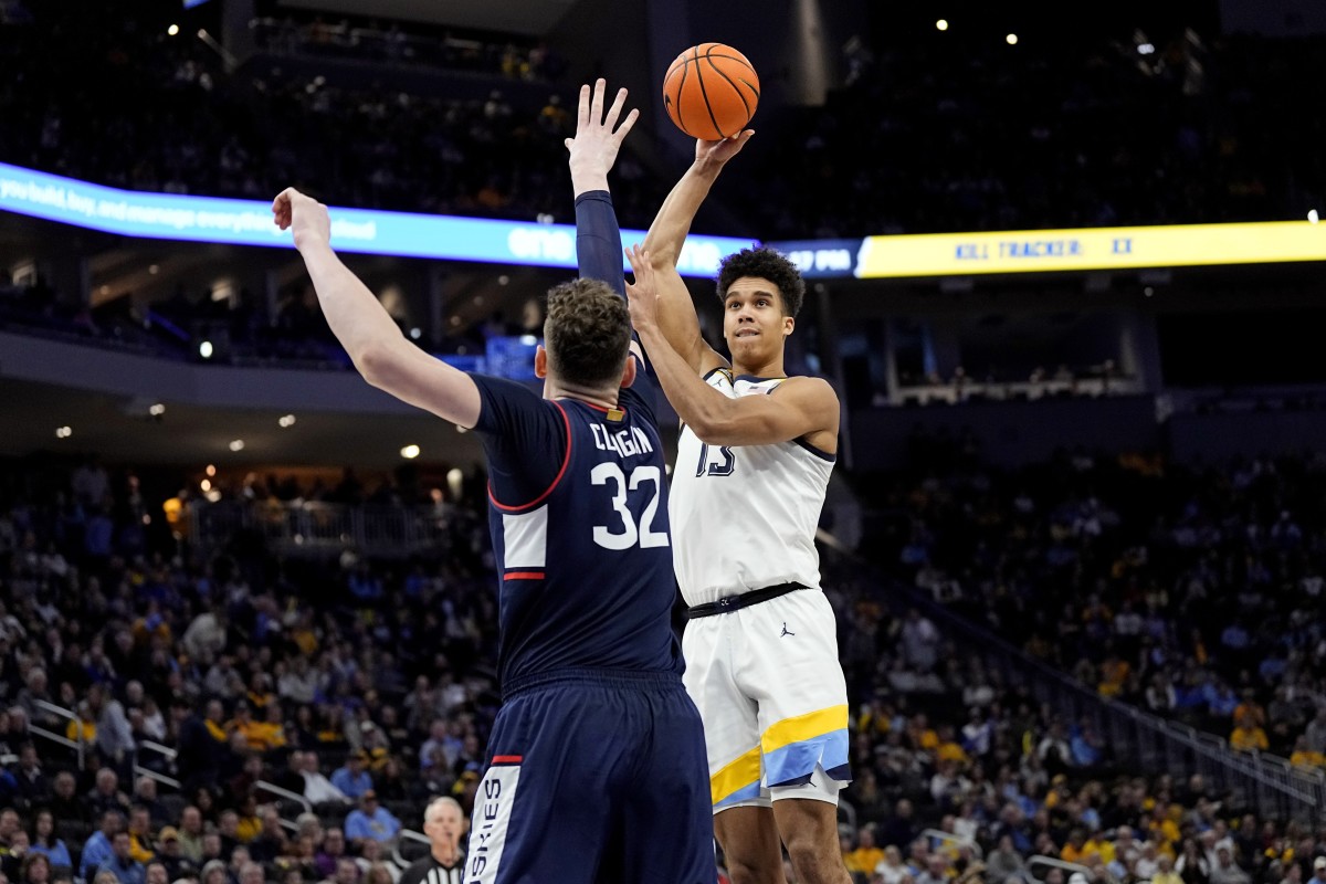 Marquette Golden Eagles forward Oso Ighodaro (13) shoots against Connecticut Huskies center Donovan Clingan (32) during the second half at Fiserv Forum.