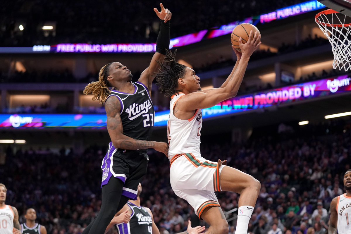 Mar 7, 2024; Sacramento, California, USA; San Antonio Spurs guard Devin Vassell (24) makes a basket in front of Sacramento Kings guard Keon Ellis (23) in the fourth quarter at the Golden 1 Center. Mandatory Credit: Cary Edmondson-USA TODAY Sports