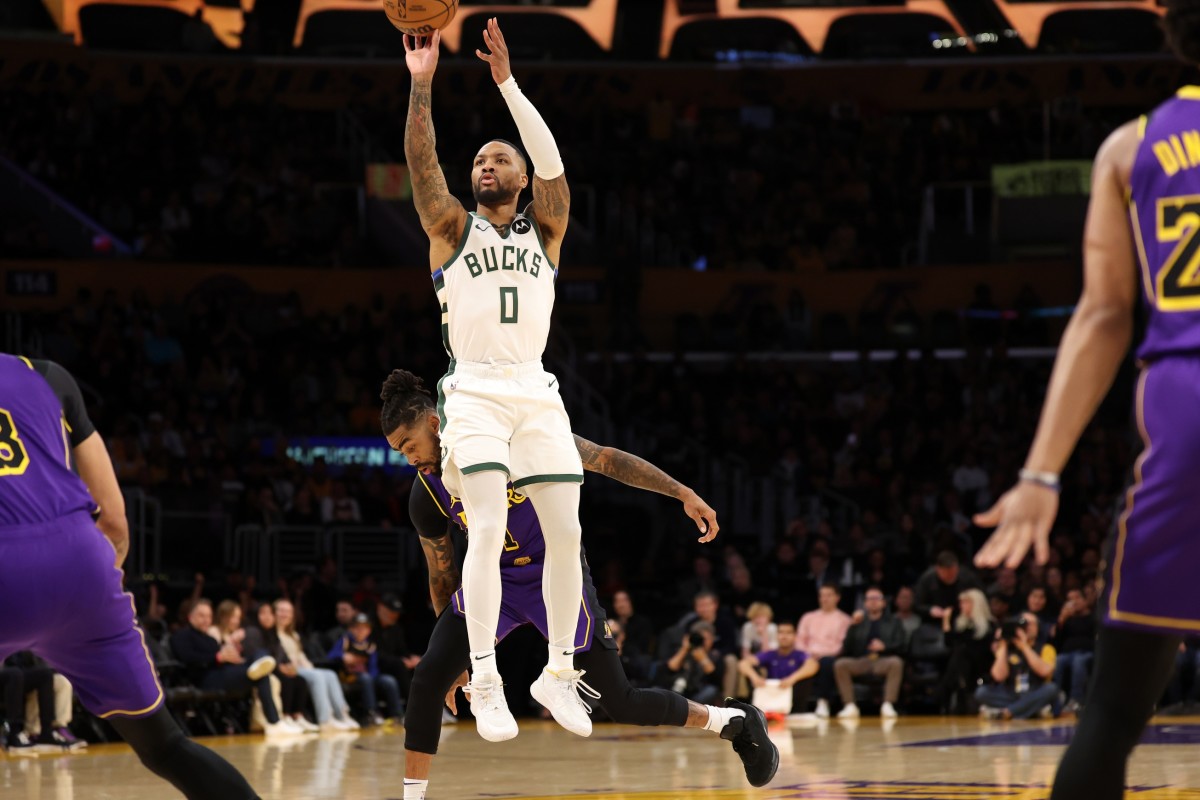 Milwaukee Bucks guard Damian Lillard (0) shoots the ball against Los Angeles Lakers guard D'Angelo Russell (1) during the first quarter at Crypto.com Arena. 