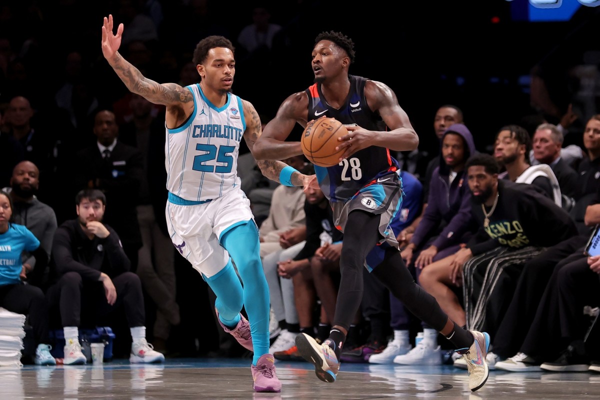Brooklyn Nets forward Dorian Finney-Smith (28) looks to pass the ball against Charlotte Hornets forward P.J. Washington (25) during the fourth quarter at Barclays Center.