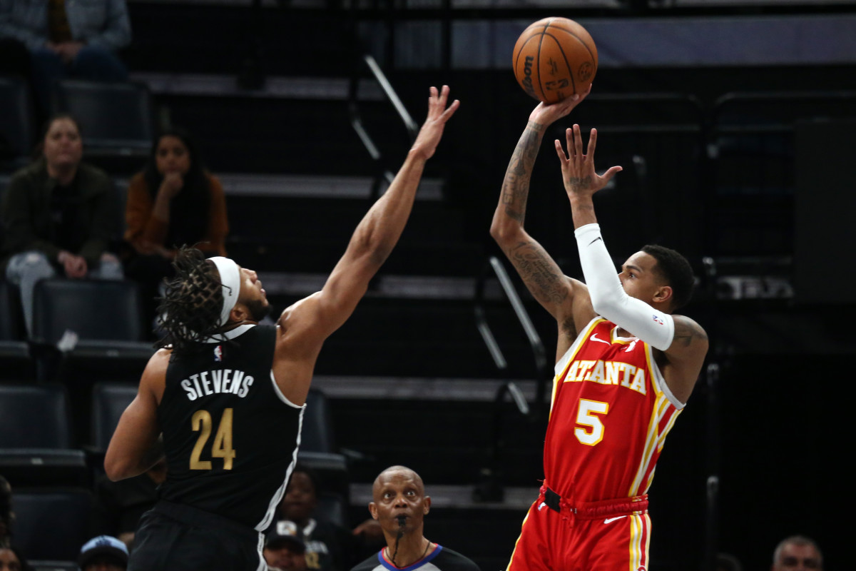 Mar 8, 2024; Memphis, Tennessee, USA; Atlanta Hawks guard Dejounte Murray (5) shoots as Memphis Grizzlies forward Lamar Stevens (24) defends during the second half at FedExForum. Mandatory Credit: Petre Thomas-USA TODAY Sports