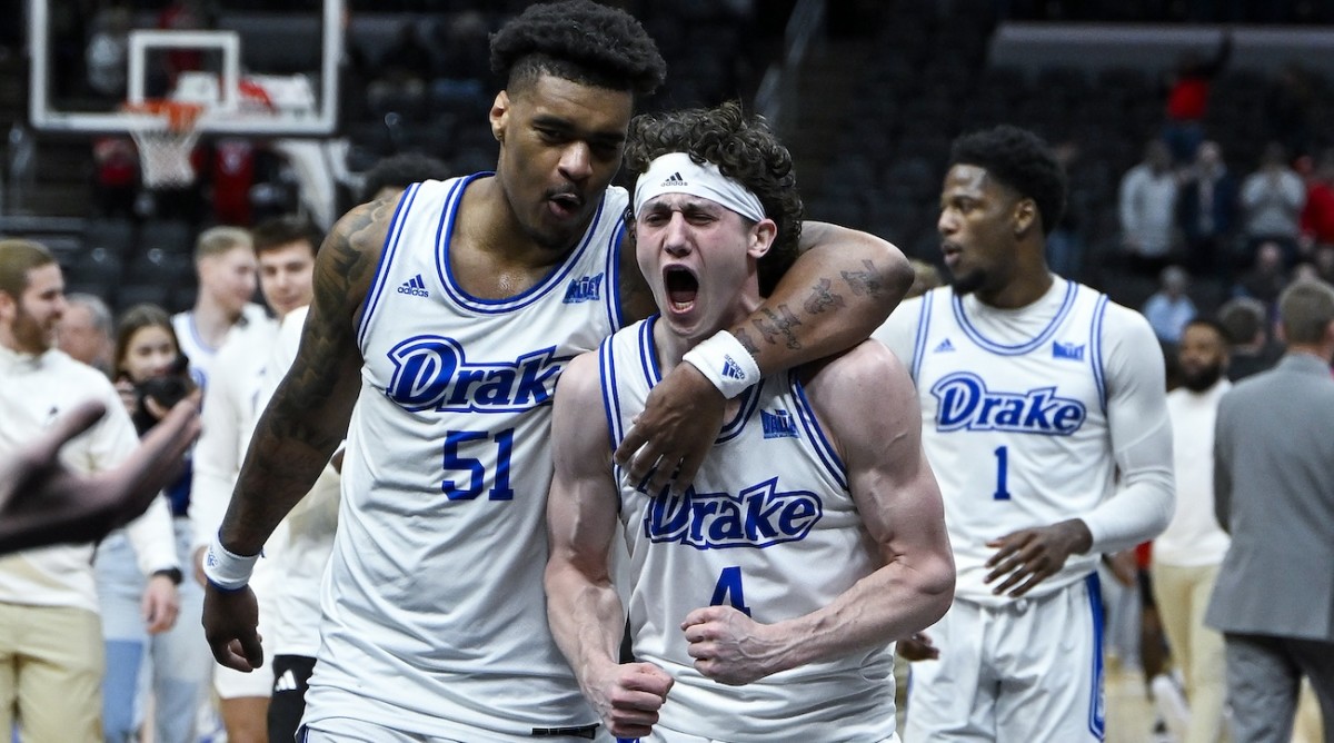 Drake Bulldogs guard Conor Enright (4) and forward Darnell Brodie (51) celebrate after the Bulldogs defeated the Bradley Braves in the Missouri Valley Conference Tournament semifinal game at Enterprise Center in St. Louis on March 9, 2024.