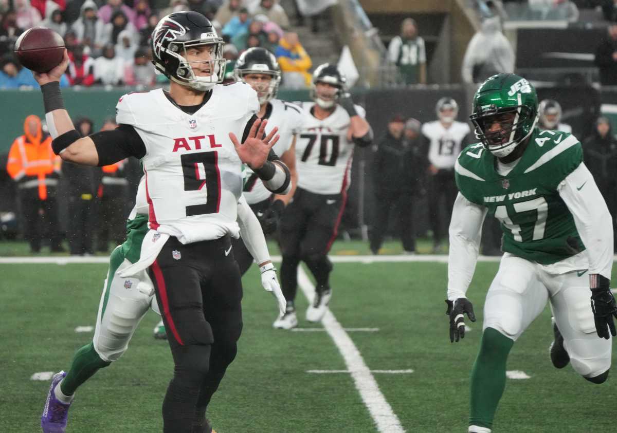 East Rutherford, NJ December 3, 2023 -- Falcons quarterback Desmond Ridder gets rid of the ball as he s pursued by Bryce Huff of the Jets in the second half. The Atlanta Falcons topped the NY Jets 13-8 at MetLife Stadium on December 3, 2023 in East Rutherford, NJ.