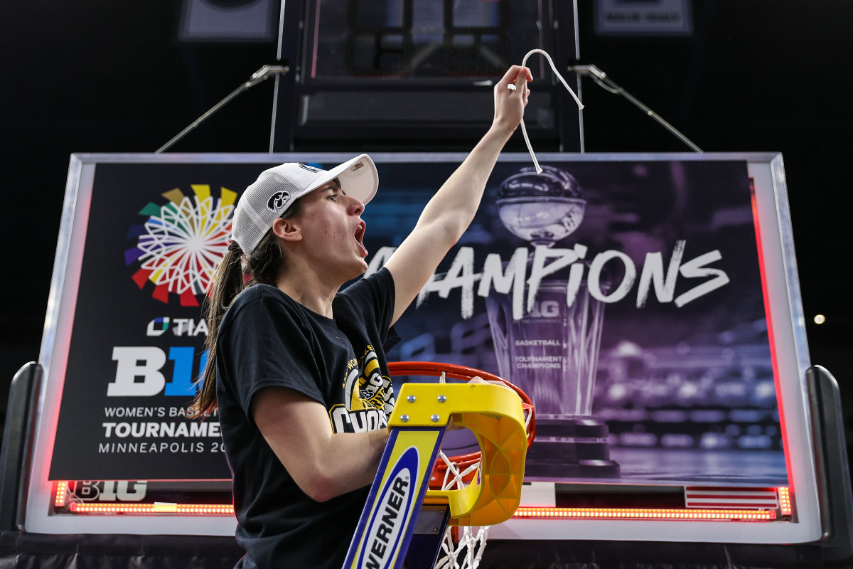 Iowa's Caitlin Clark (22) cuts a piece off the net after the game against the Nebraska Cornhuskers at Target Center on March 10, 2024 in Minneapolis. (Matt Krohn/USA TODAY Sports)