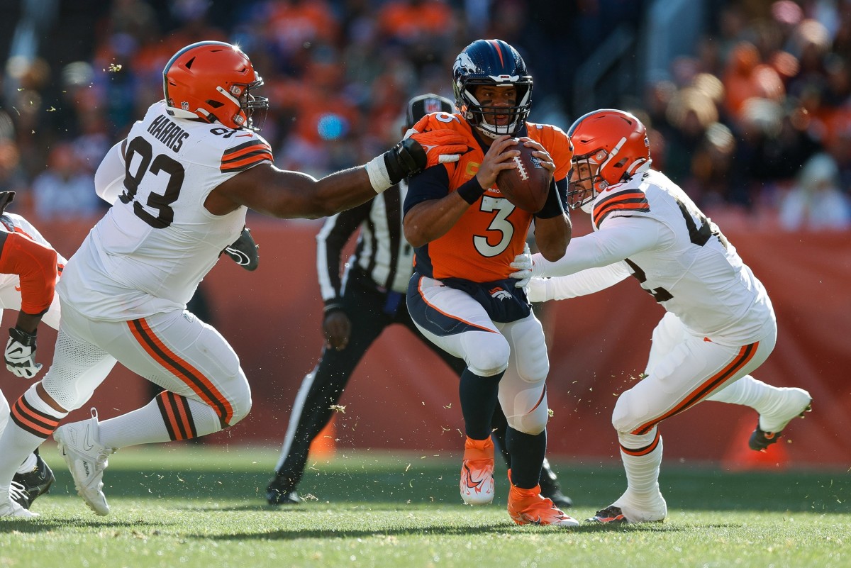 Nov 26, 2023; Denver, Colorado, USA; Denver Broncos quarterback Russell Wilson (3) looks to pass under pressure from Cleveland Browns defensive tackle Shelby Harris (93) an dlinebacker Tony Fields II (42) in the first quarter at Empower Field at Mile High. Mandatory Credit: Isaiah J. Downing-USA TODAY Sports
