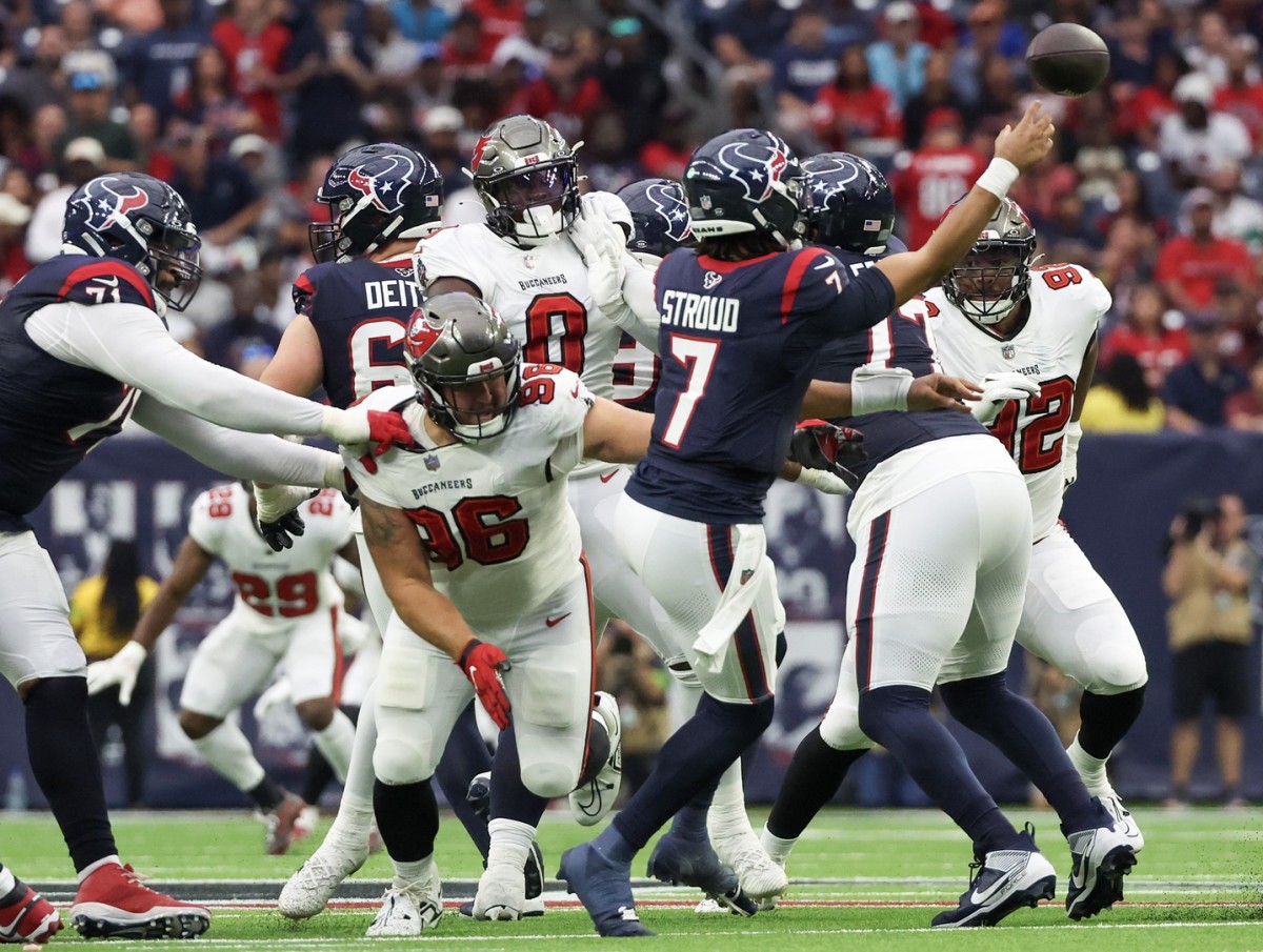 Houston Texans quarterback C.J. Stroud (7) passes as he is pressured from Tampa Bay Buccaneers defensive tackle Greg Gaines (96). Mandatory Credit: Thomas Shea-USA TODAY Sports