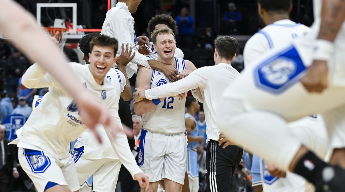 Drake Bulldogs guard Tucker DeVries (12) celebrates with teammates after Drake defeated the Indiana State Sycamores to win the Missouri Valley Conference Tournament Championship at Enterprise Center in St. Louis on March 10, 2024.