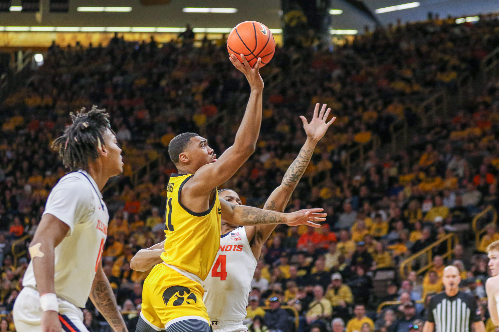Iowa's Tony Perkins (11) releases a shot during a game against Illinois on March 10, 2024 at Carver-Hawkeye Arena in Iowa City, Iowa. (Rob Howe/HN)