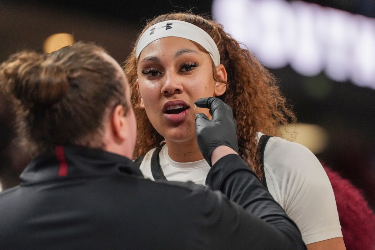 Mar 10, 2024; Greensville, SC, USA; A trainer treats the lip of South Carolina Gamecocks center Kamilla Cardoso (10) during the second half against the LSU Lady Tigers at Bon Secours Wellness Arena.