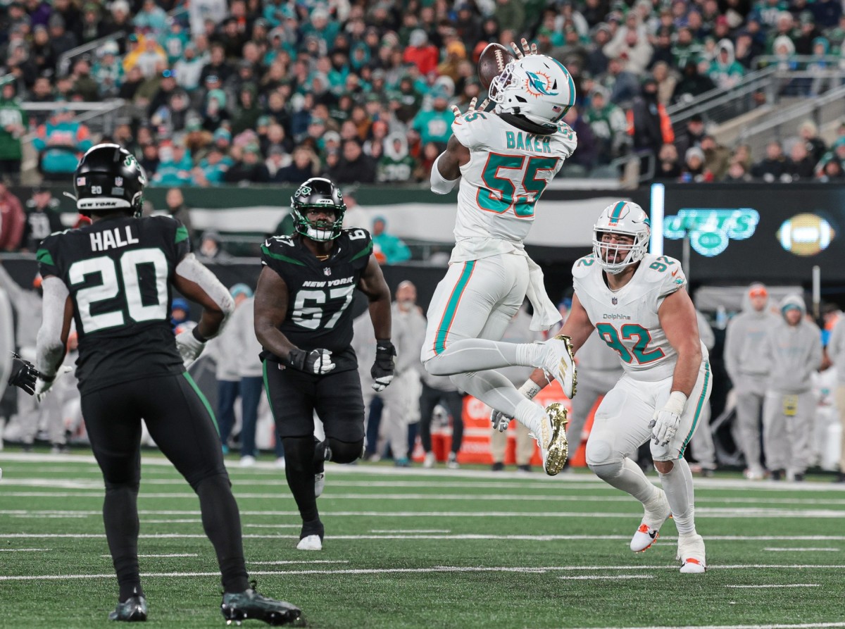 Miami Dolphins linebacker Jerome Baker (55) intercepts a pass against the New York Jets. Mandatory Credit: Vincent Carchietta-USA TODAY Sports