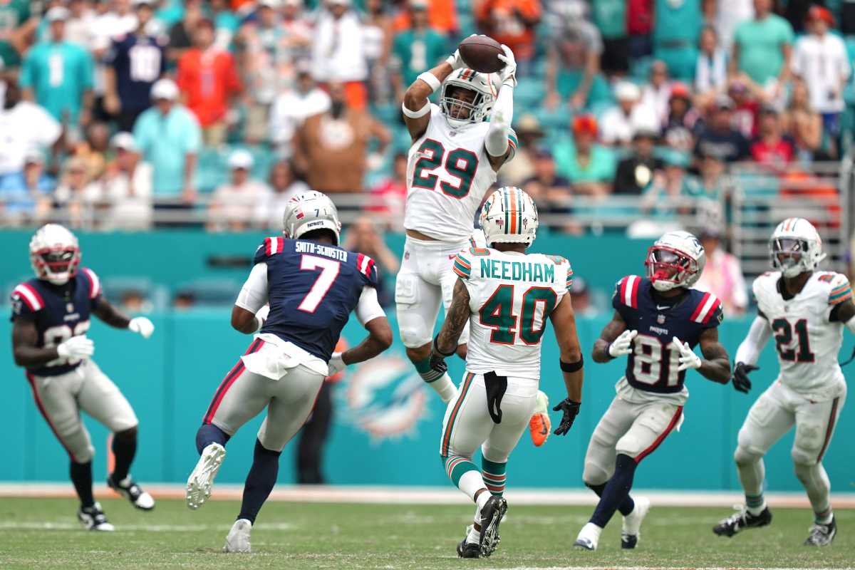 Miami Dolphins safety Brandon Jones (29) goes up for an interception as New England Patriots wide receiver JuJu Smith-Schuster (7) closes in during the second half of an NFL game at Hard Rock Stadium in Miami Gardens, Oct. 29, 2023.