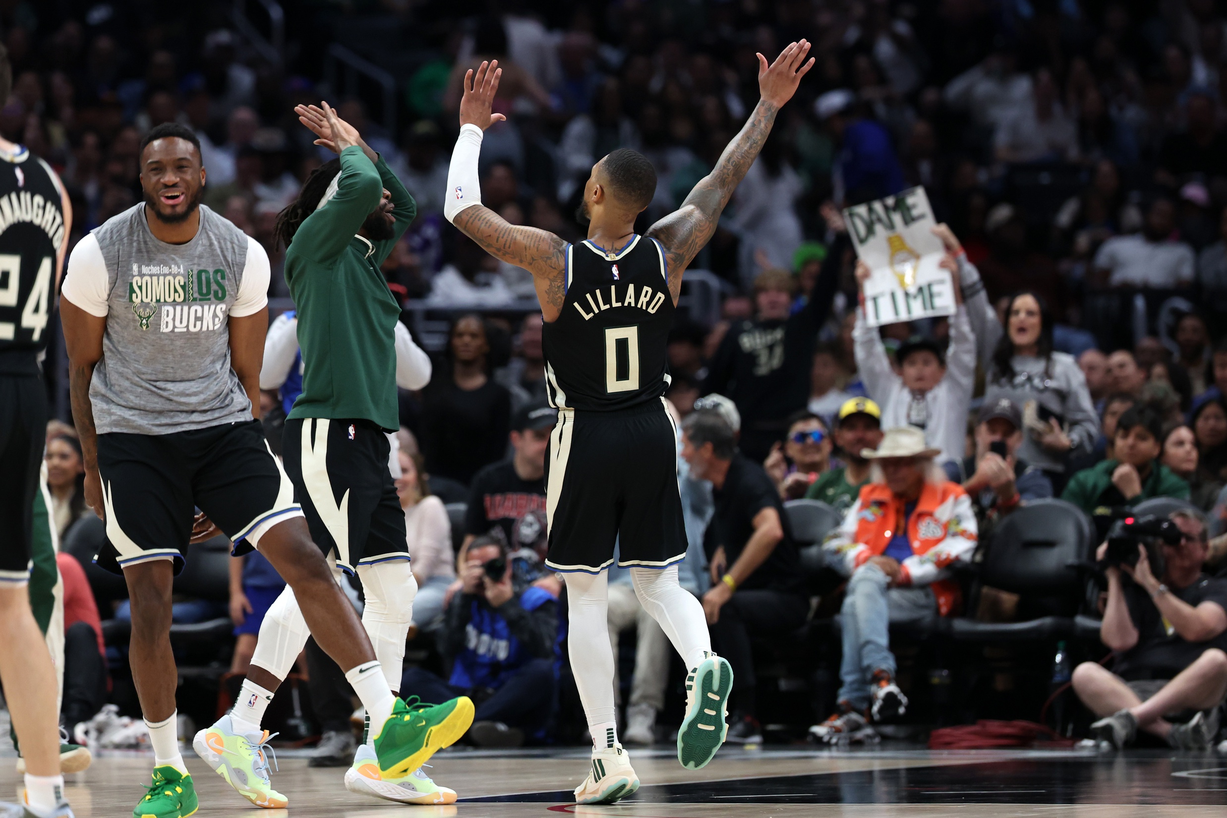 Milwaukee Bucks guard Damian Lillard (0) celebrates with teammates after making a three point basket in the fourth quarter against the Los Angeles Clippers