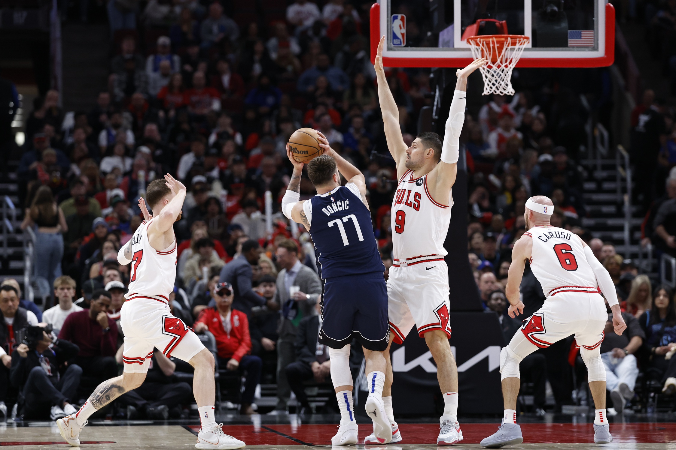 Dallas Mavericks guard Luka Doncic (77) shoots against the Chicago Bulls during the first half at United Center. 