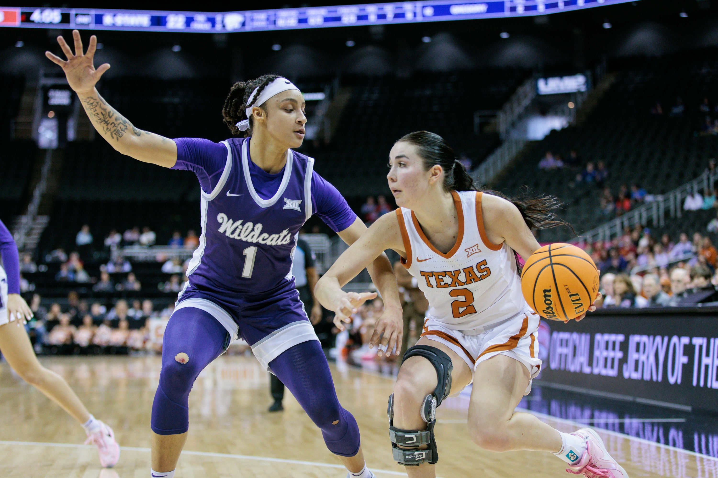 Mar 11, 2024; Kansas City, MO, USA; Texas Longhorns guard Shaylee Gonzales (2) drives to the basket around Kansas State Wildcats guard Zyanna Walker (1) during the first half at T-Mobile Center.