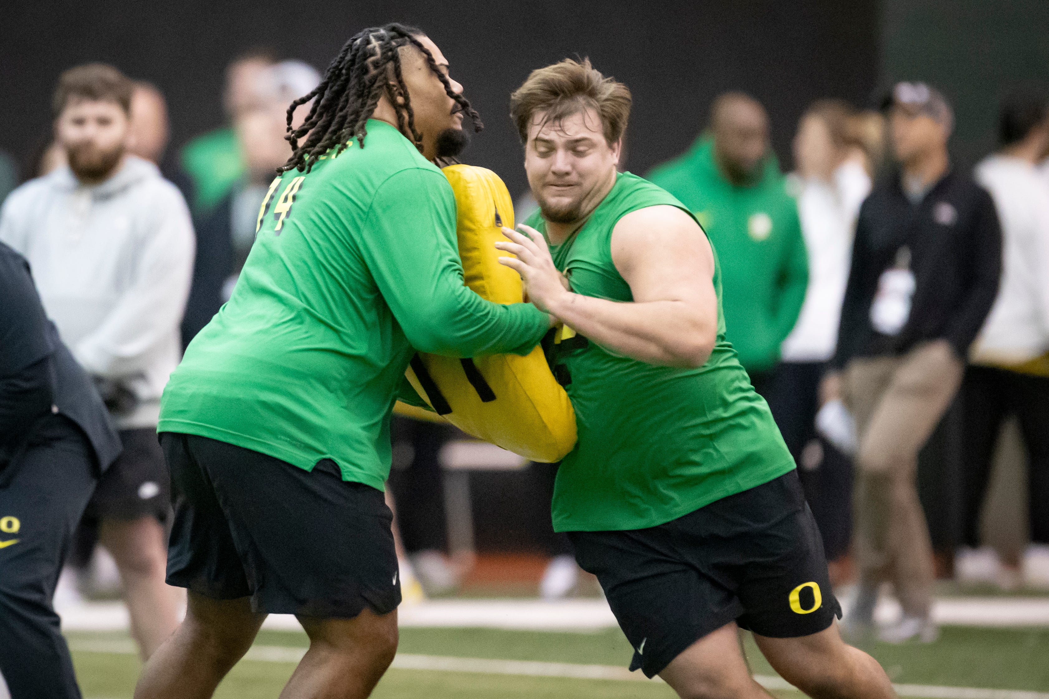 Center Jackson Powers-Johnson goes through a blocking drill with Steven Jones at Oregon's 2024 Pro Day.