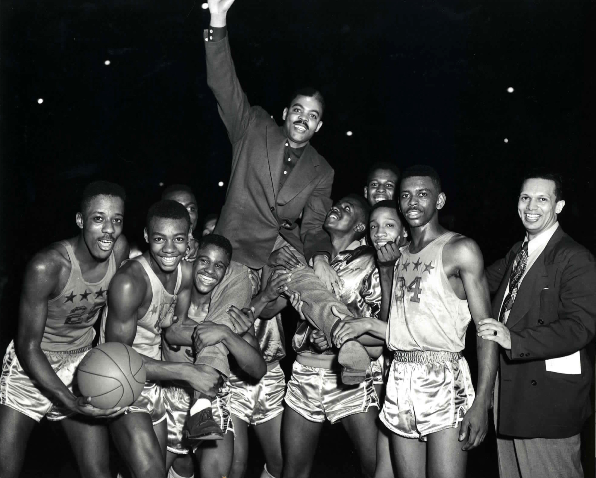 Crispus Attucks celebrates with coach Ray Crowe.