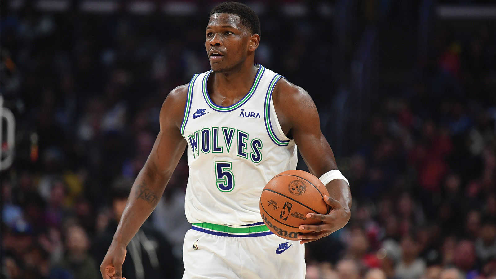 Minnesota Timberwolves guard Anthony Edwards moves the ball up court.