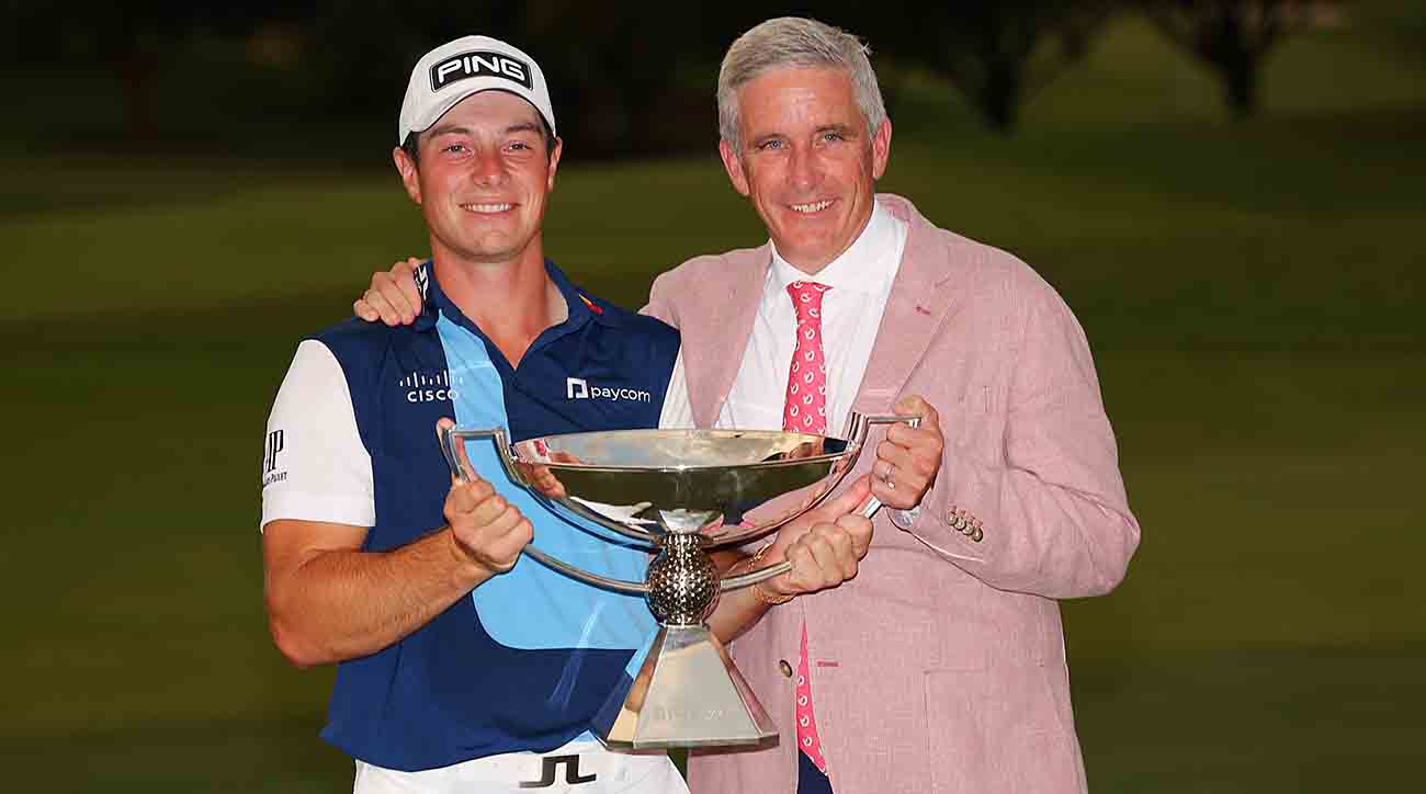 Viktor Hovland celebrates with the FedExCup and PGA Tour commissioner Jay Monahan after winning the 2023 Tour Championship at East Lake Golf Club in Atlanta, Ga.