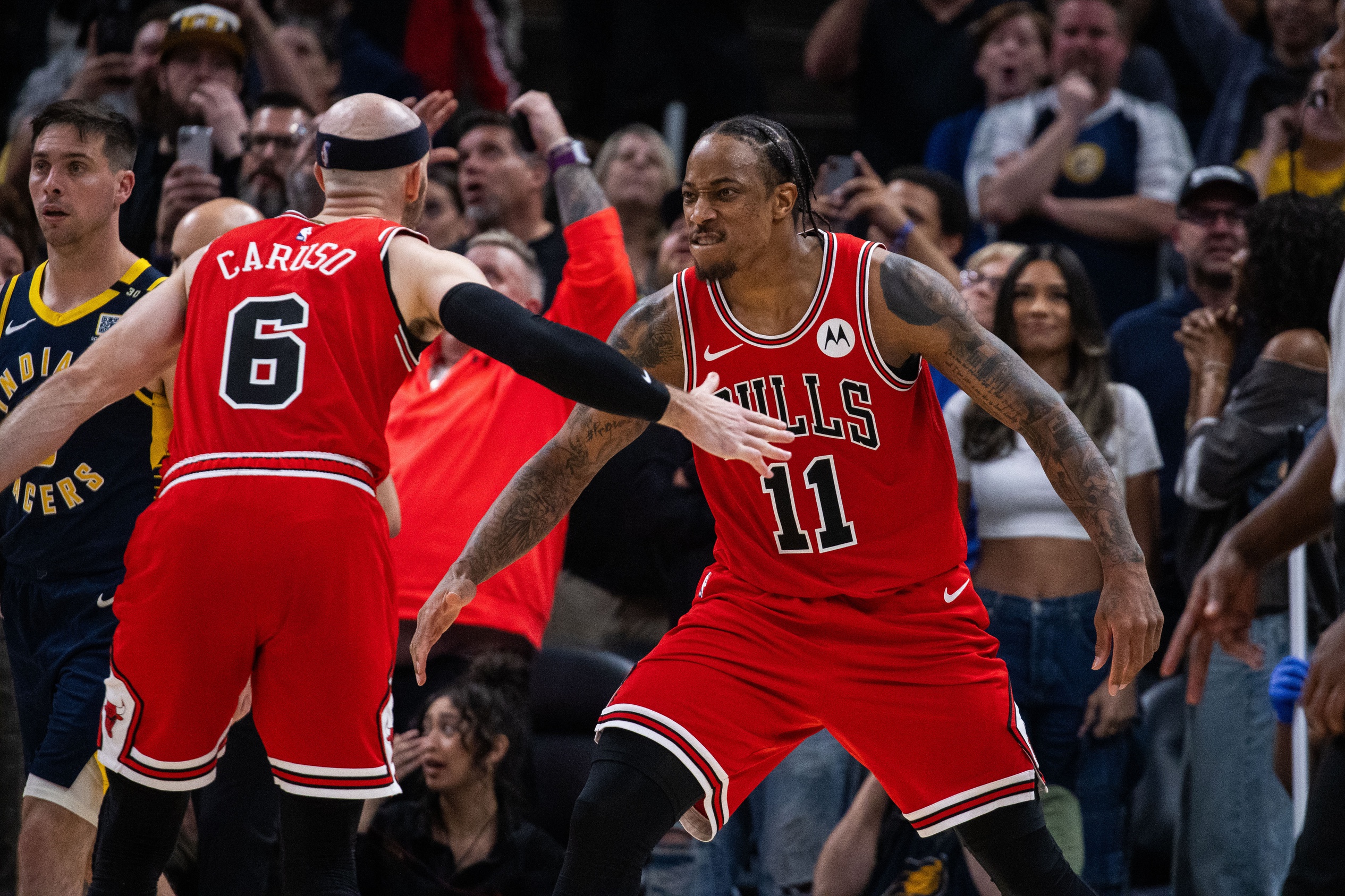 Chicago Bulls forward DeMar DeRozan (11) and guard Alex Caruso (6) celebrate a basket to tie the game and go to overtime against the Indiana Pacers at Gainbridge Fieldhouse
