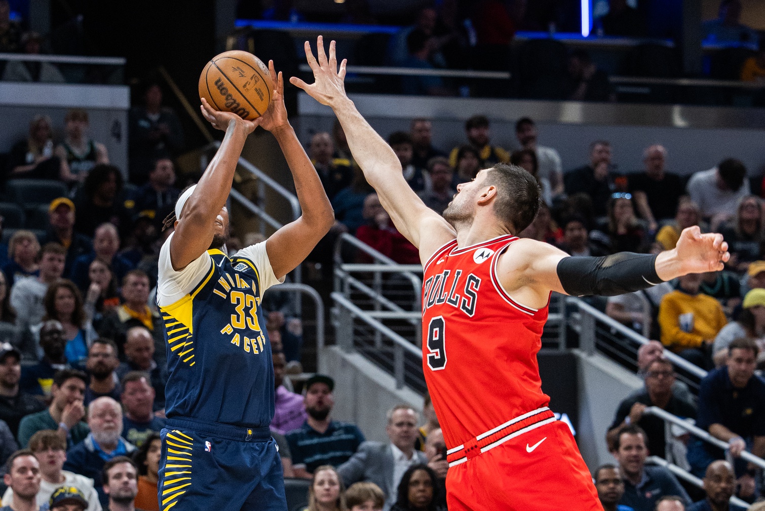 Indiana Pacers center Myles Turner (33) shoots the ball while Chicago Bulls center Nikola Vucevic (9) defends in the second half at Gainbridge Fieldhouse.