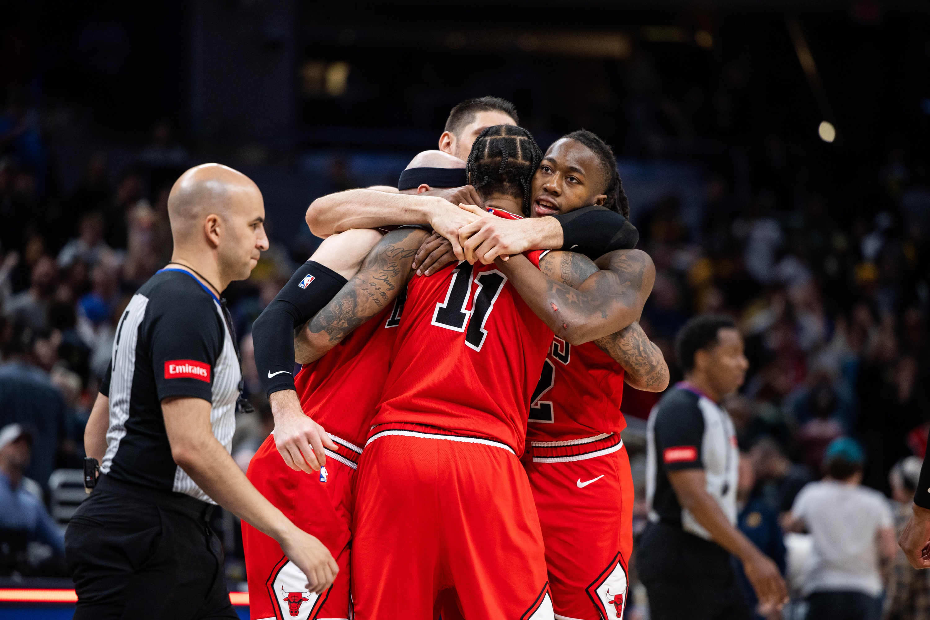  Chicago Bulls team hug after beating the Indiana Pacers in overtime at Gainbridge Fieldhouse.