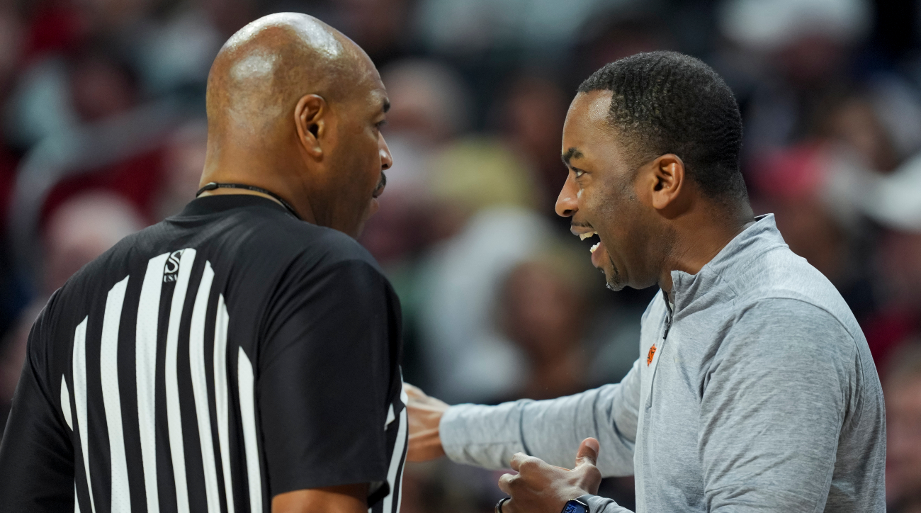 Feb 21, 2024; Cincinnati, Ohio, USA; Oklahoma State Cowboys head coach Mike Boynton, right, talks with an official during the game against the Cincinnati Bearcats in the second half at Fifth Third Arena.