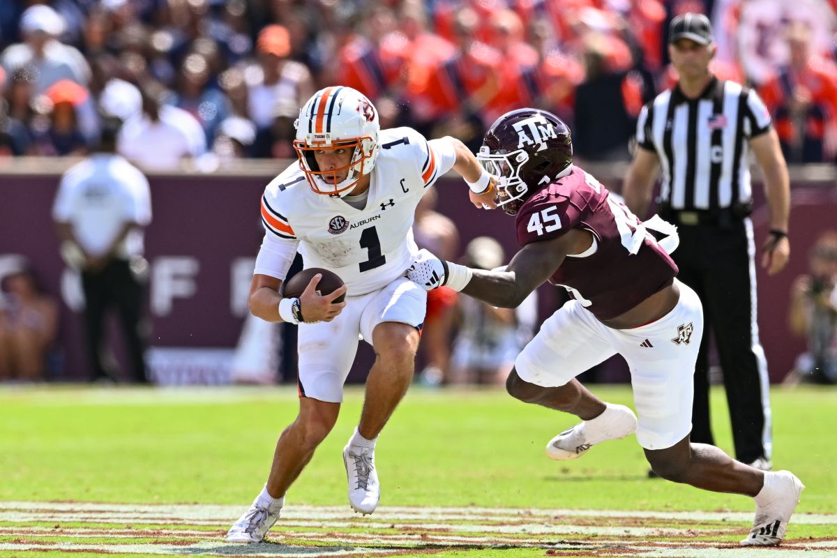 Auburn Tigers quarterback Payton Thorne (1) runs the ball on a quarterback keeper as Texas A&M Aggies linebacker Edgerrin Cooper (45) attempts a tackle during the second quarter at Kyle Field.