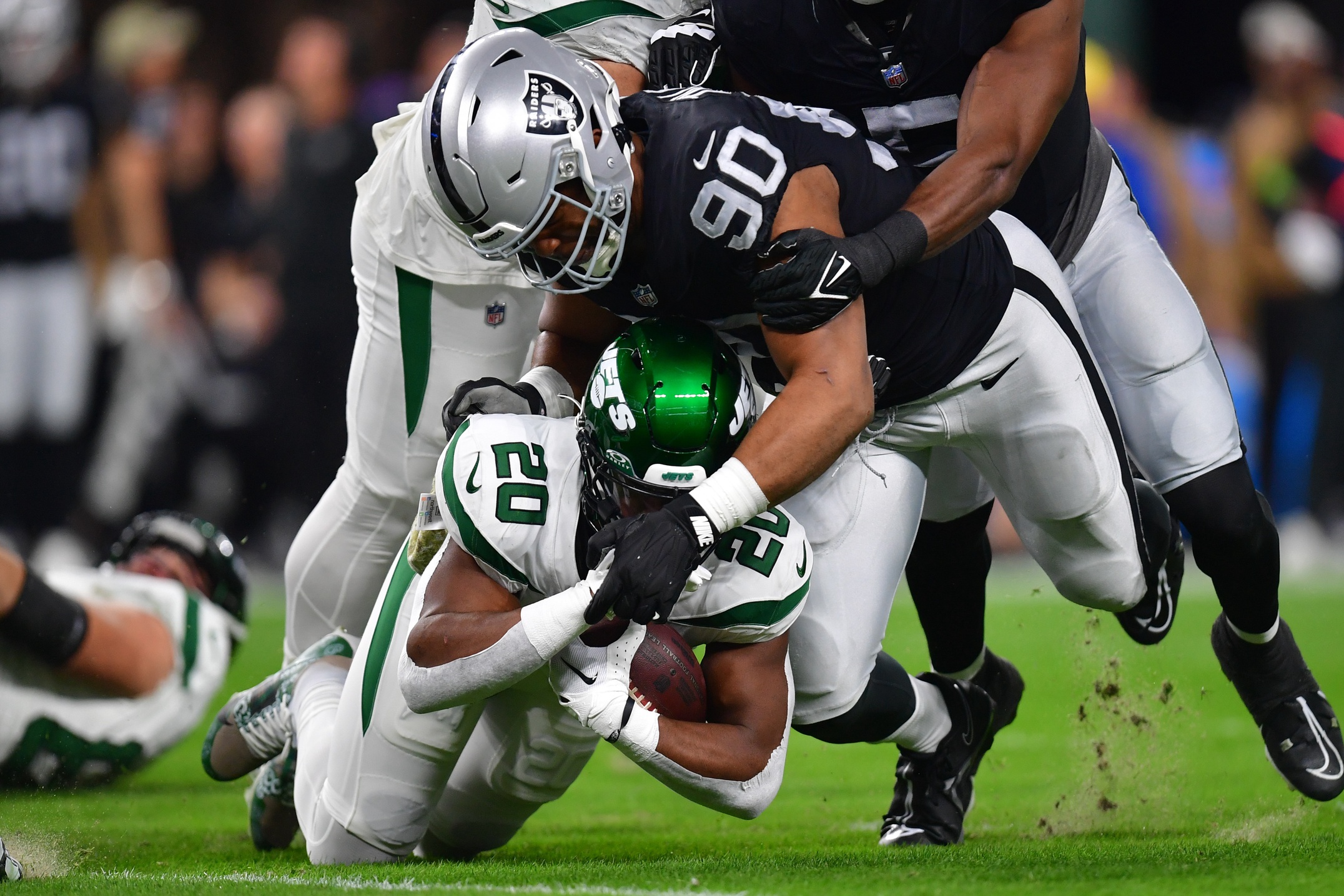 Nov 12, 2023; Paradise, Nevada, USA; Las Vegas Raiders defensive tackle Jerry Tillery (90) brings down New York Jets running back Breece Hall (20) during the first half at Allegiant Stadium.