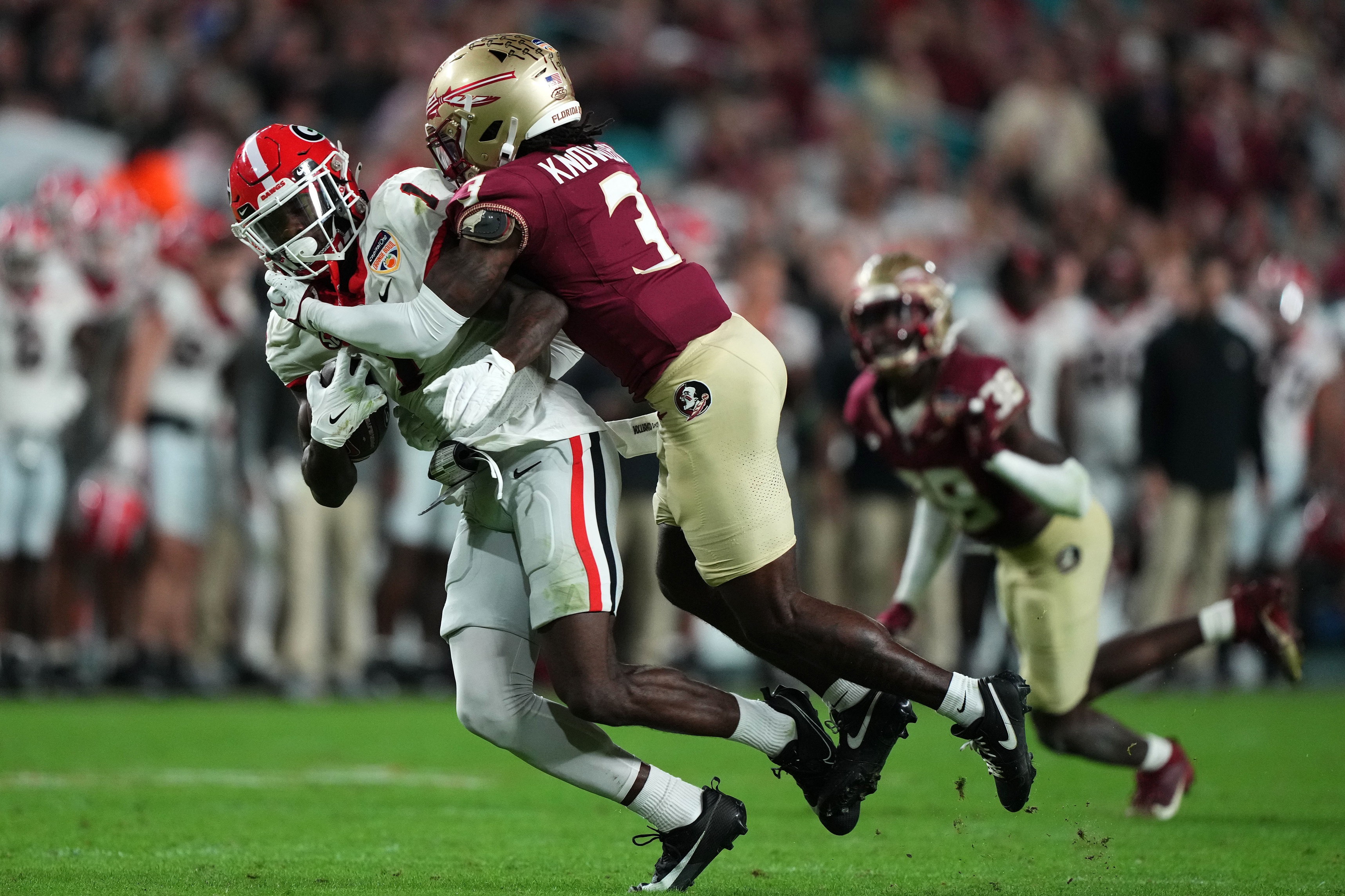Dec 30, 2023; Miami Gardens, FL, USA; Georgia Bulldogs wide receiver Marcus Rosemy-Jacksaint (1) makes a catch against Florida State Seminoles defensive back Kevin Knowles II (3) during the second half in the 2023 Orange Bowl at Hard Rock Stadium. Mandatory Credit: Jasen Vinlove-USA TODAY Sports  
