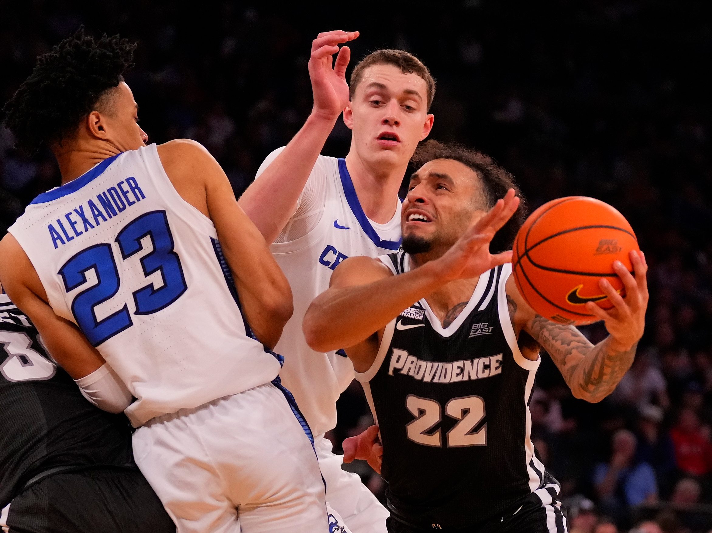 Mar 14, 2024; New York City, NY, USA; Providence Friars guard Devin Carter (22) drives on Creighton Bluejays guard Trey Alexander (23) and center Ryan Kalkbrenner (11) during the second half at Madison Square Garden.