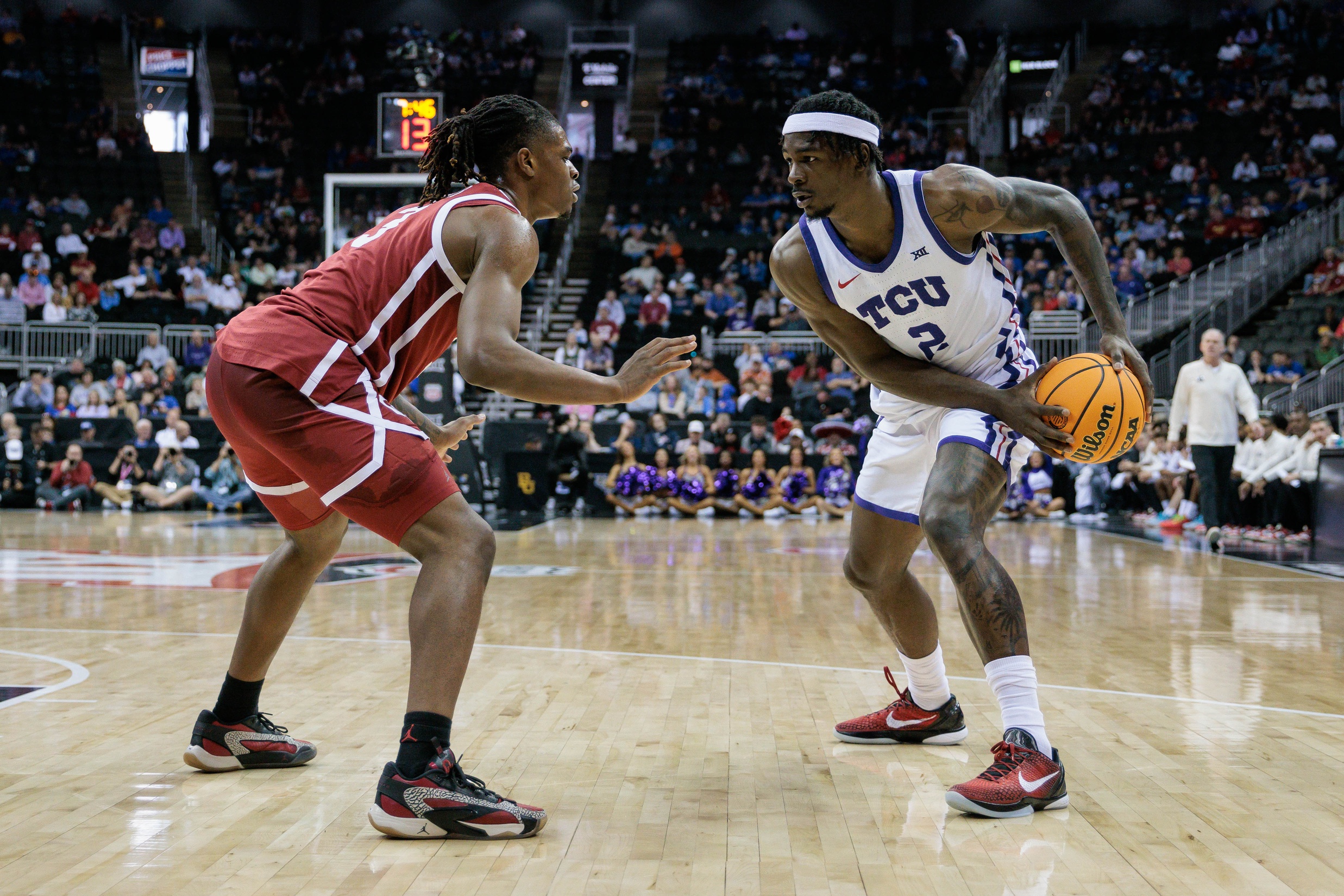 Mar 13, 2024; Kansas City, MO, USA; Oklahoma Sooners guard Otega Oweh (3) guards TCU Horned Frogs forward Emanuel Miller (2) during the first half at T-Mobile Center.
