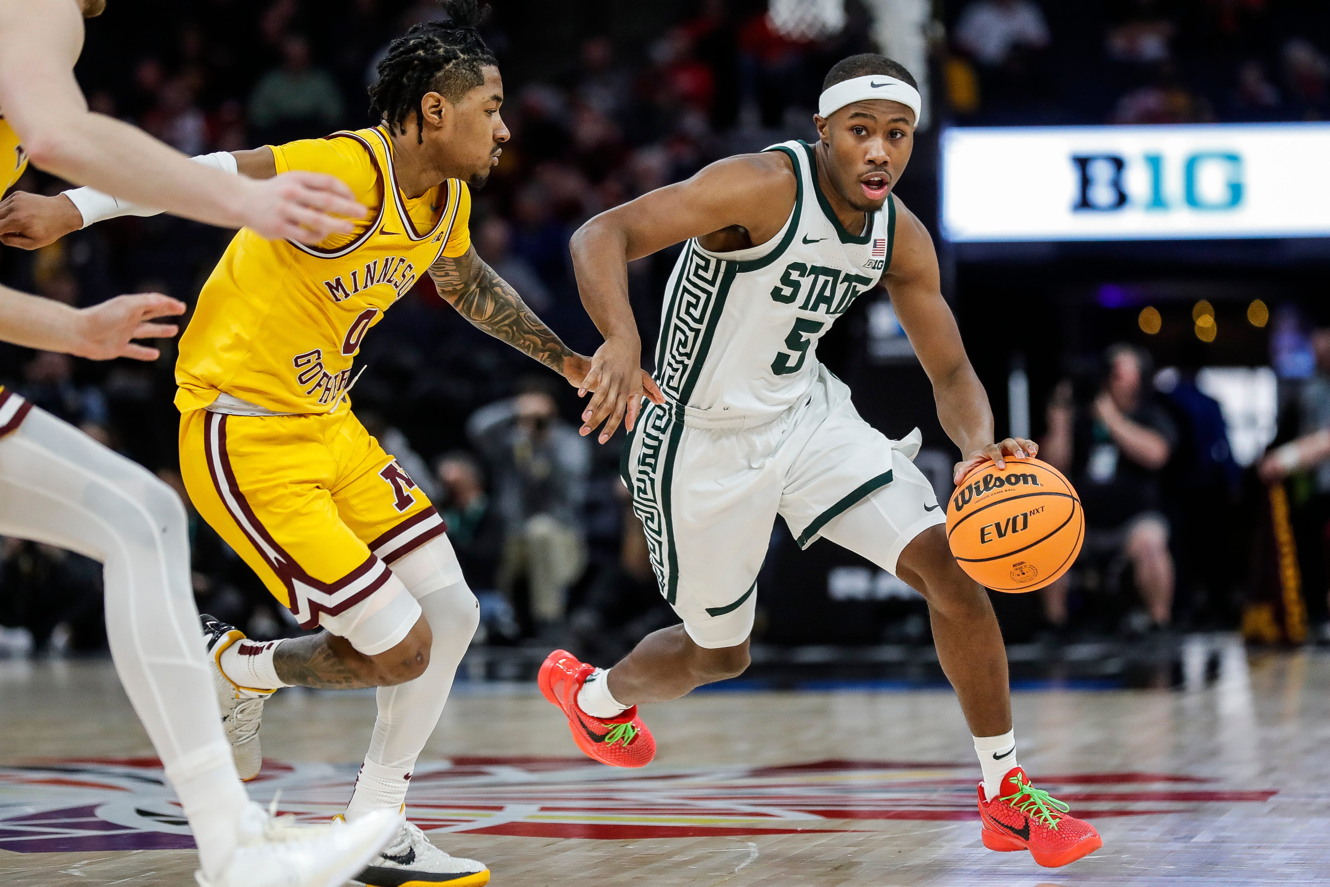 Michigan State guard Tre Holloman (5) dribbles against Minnesota guard Elijah Hawkins (0) during the second half of Second Round of Big Ten tournament at Target Center in Minneapolis, Minn. on Thursday, March 14, 2024.